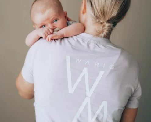 Imetysohjaus Helsinki ja Tampere. Imetysohjaaja pitaa vauvaa olallaan.